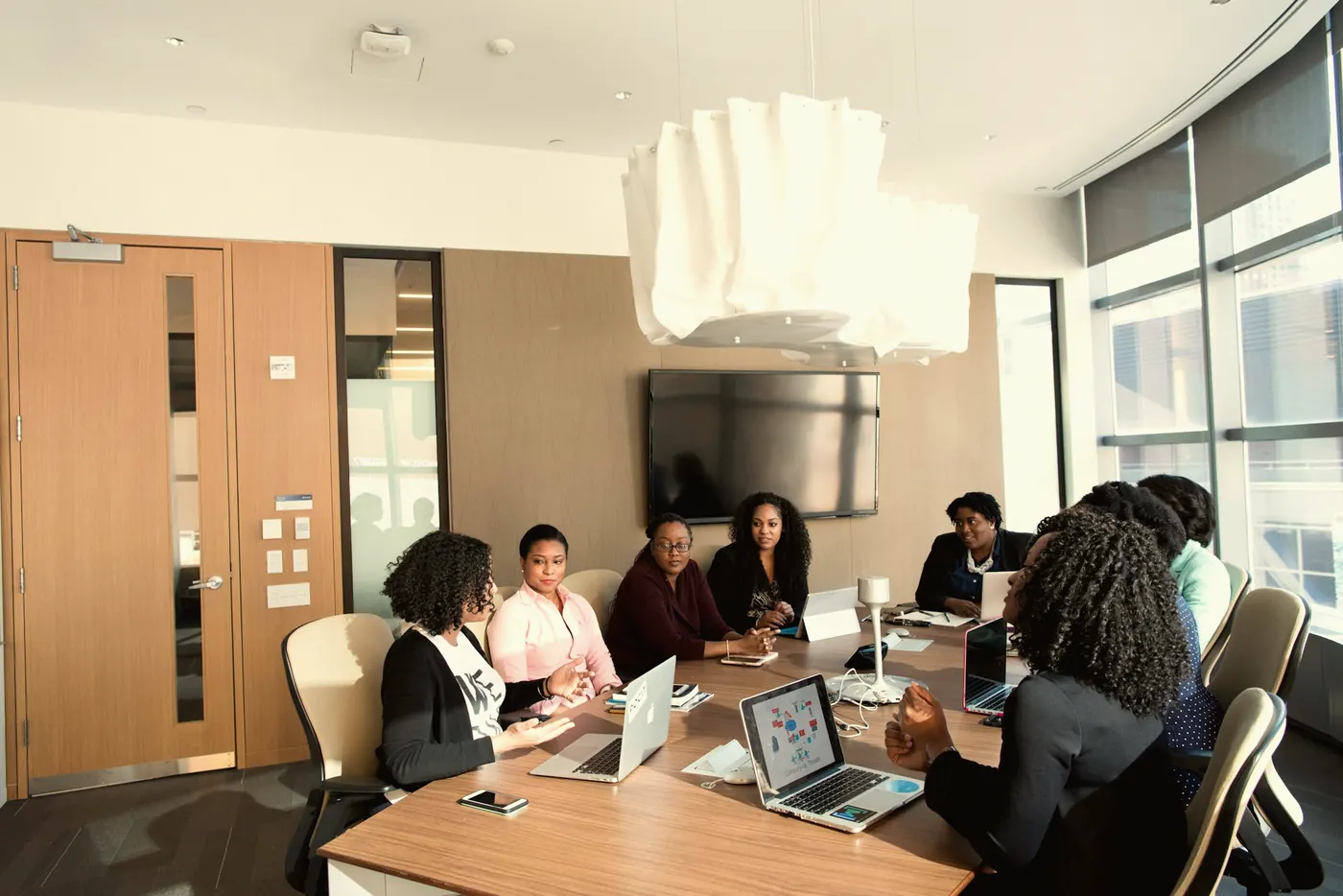 A team of colleagues in a meeting around a boardroom table